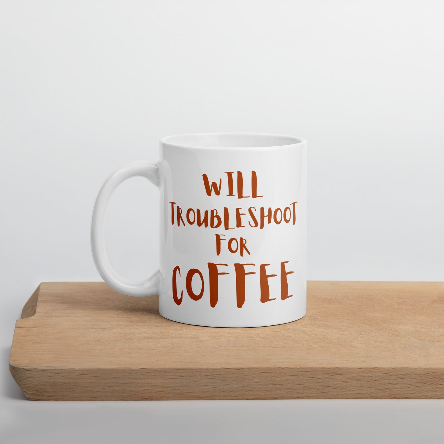 White ceramic mug for I.T. pros with 'Will Troubleshoot for Coffee' quote and tech humor.